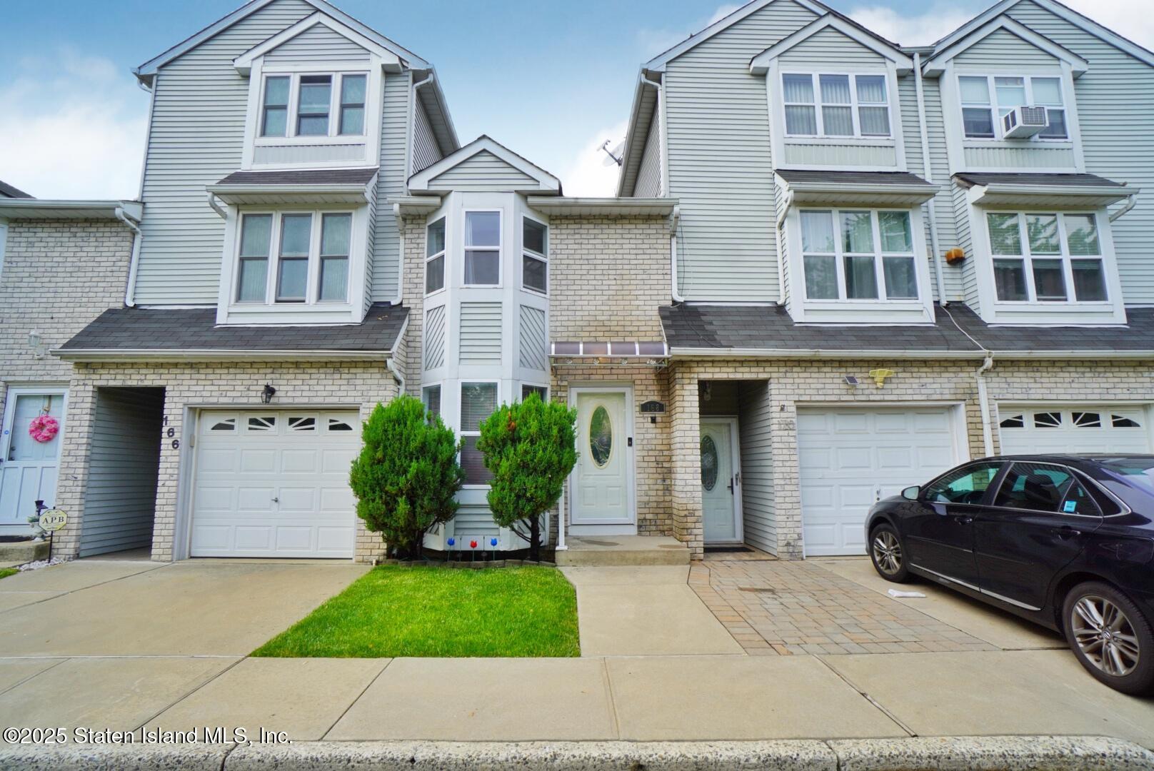 168 Rosedale Avenue Staten Island, NY 10312 - Photo 1 of 21 a front view of a house with a yard