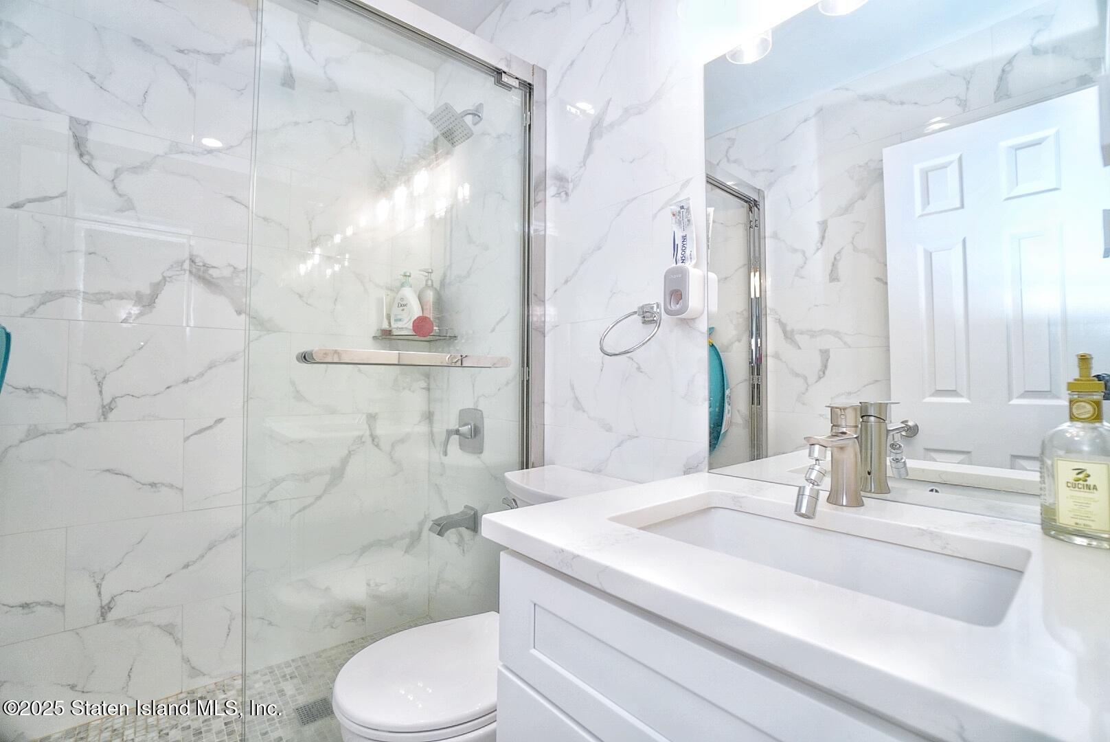 168 Rosedale Avenue Staten Island, NY 10312 - Photo 14 of 21 a bathroom with a sink toilet and shower
