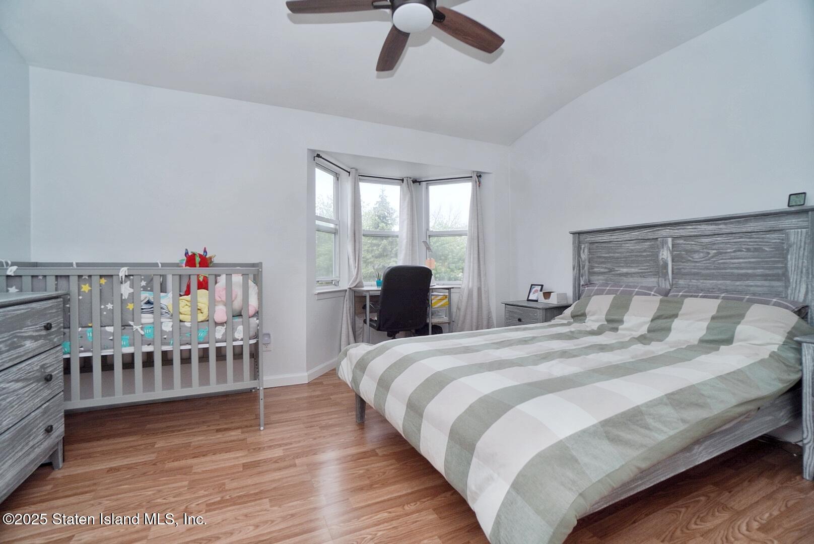 168 Rosedale Avenue Staten Island, NY 10312 - Photo 16 of 21 a bedroom with a bed and a large window