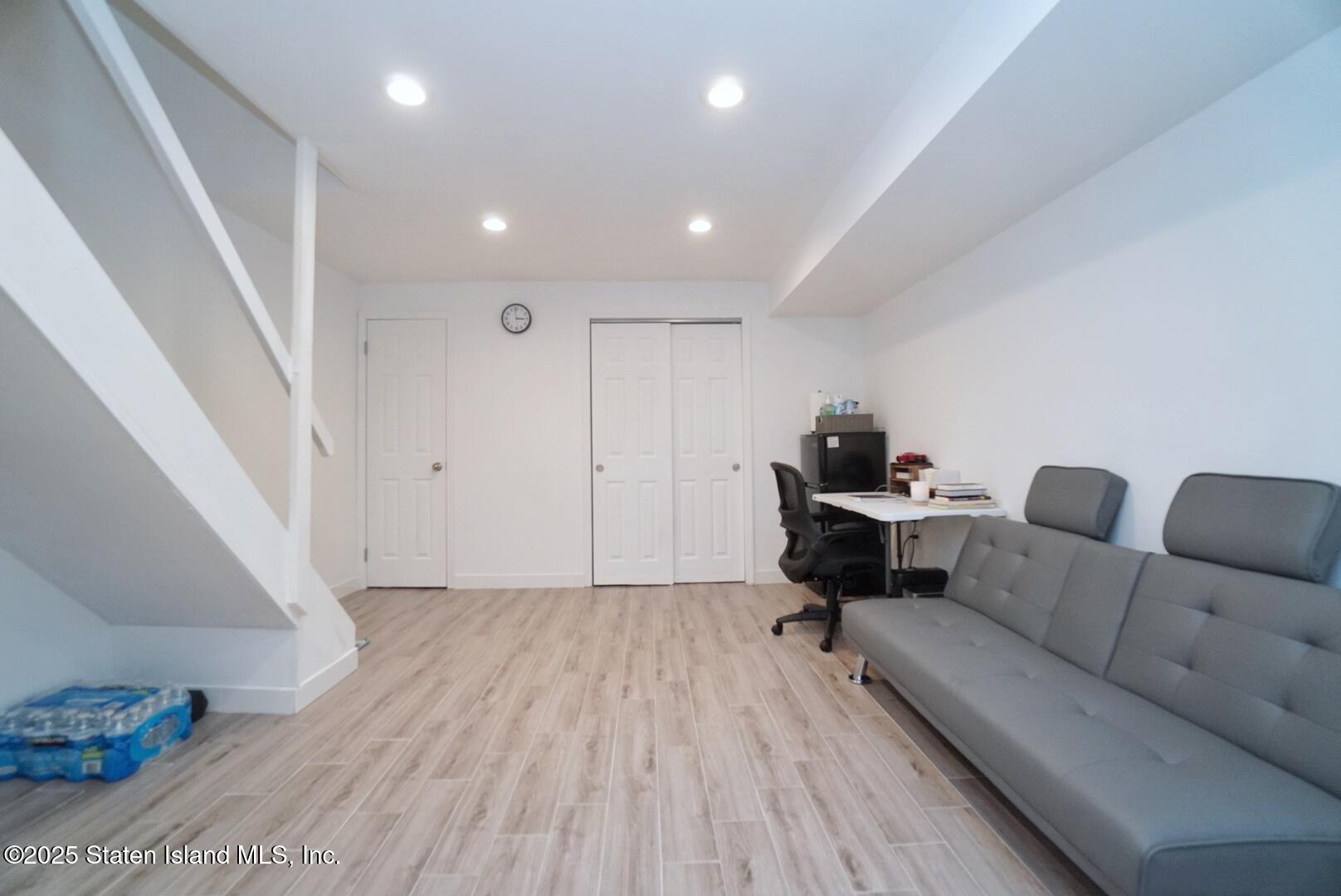 168 Rosedale Avenue Staten Island, NY 10312 - Photo 17 of 21 a living room with furniture and a wooden floor