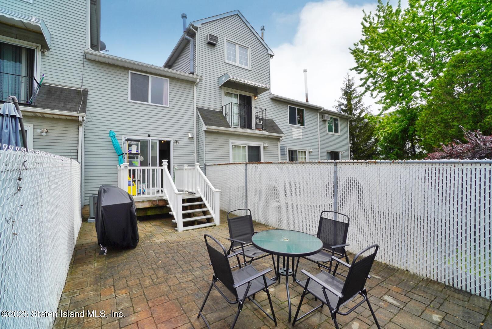 168 Rosedale Avenue Staten Island, NY 10312 - Photo 20 of 21 a view of a patio with couches table and chairs and potted plants