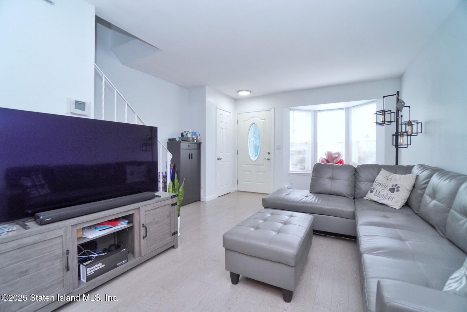 168 Rosedale Avenue Staten Island, NY 10312 - Photo 4 of 21 a living room with furniture and a flat screen tv