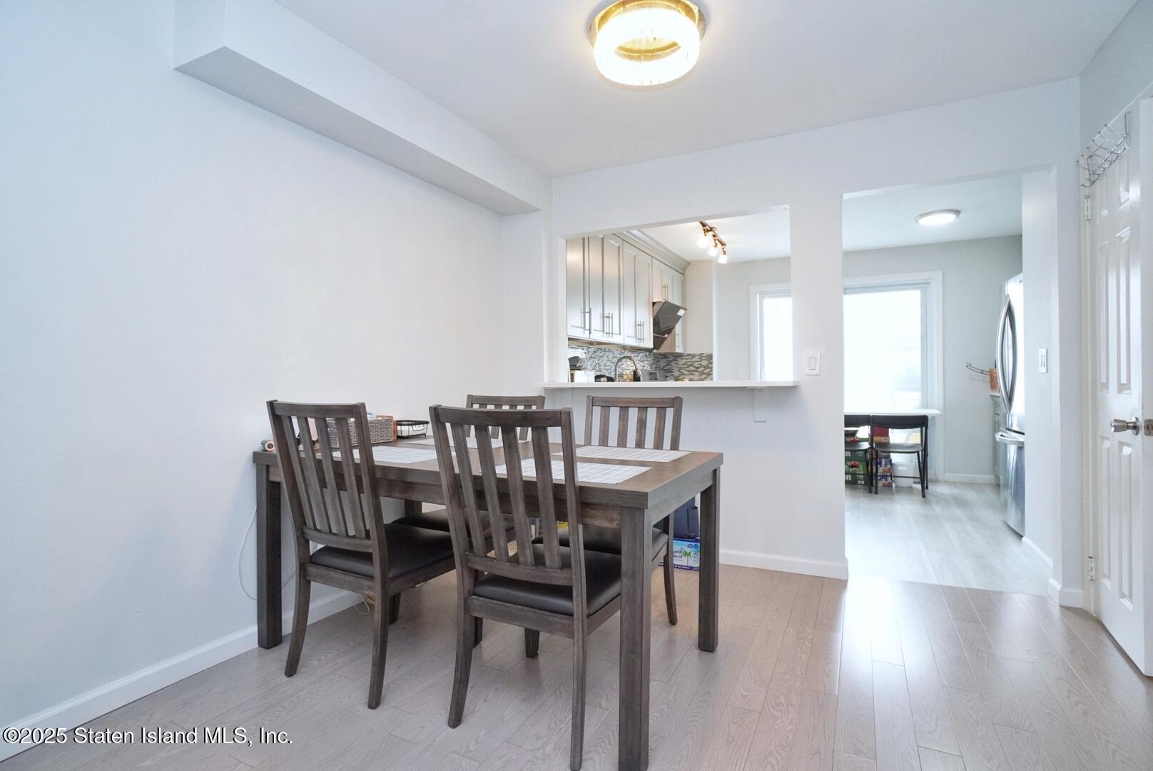 168 Rosedale Avenue Staten Island, NY 10312 - Photo 5 of 21 a view of a dining room with furniture and wooden floor