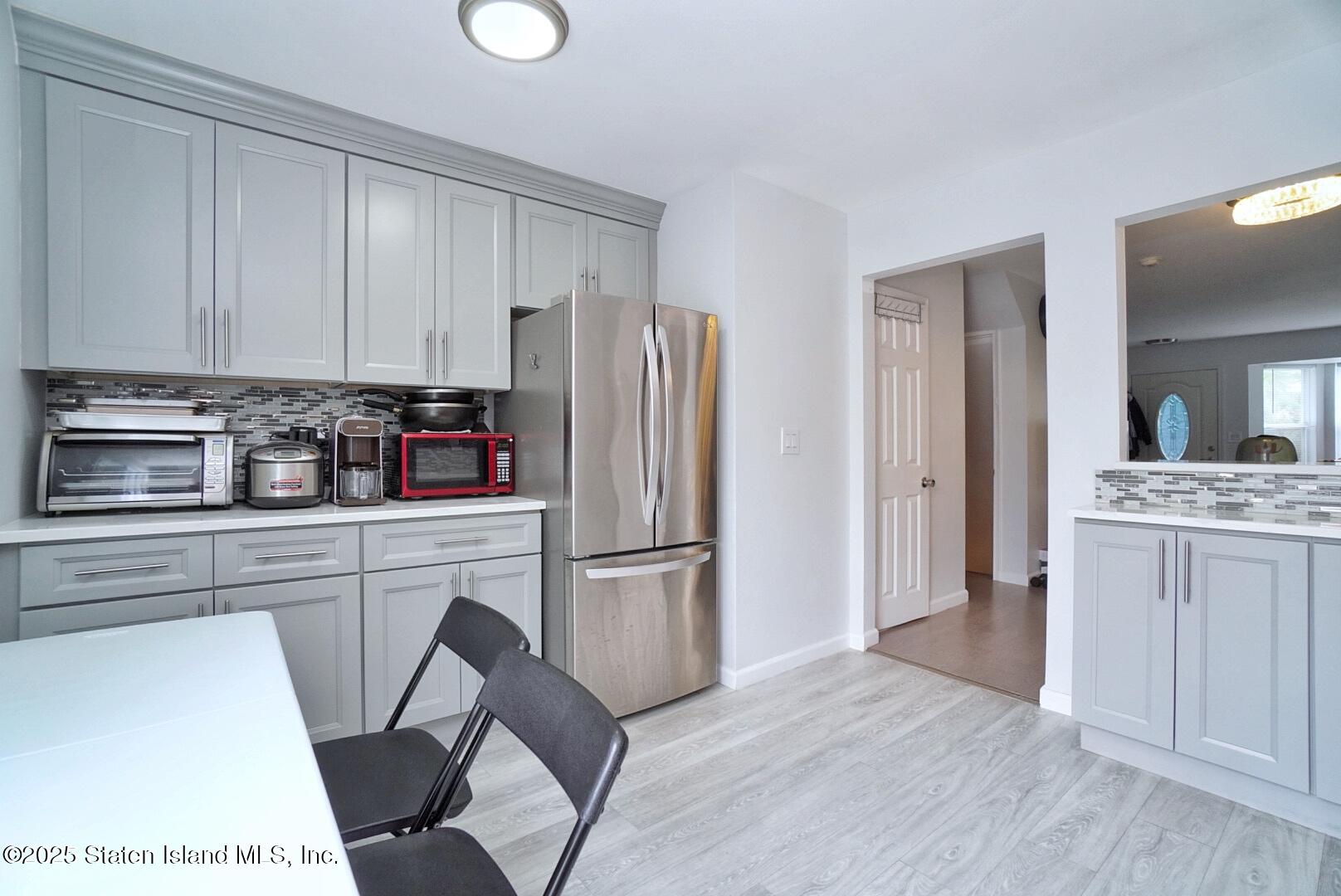 168 Rosedale Avenue Staten Island, NY 10312 - Photo 7 of 21 a kitchen with white cabinets and stainless steel appliances