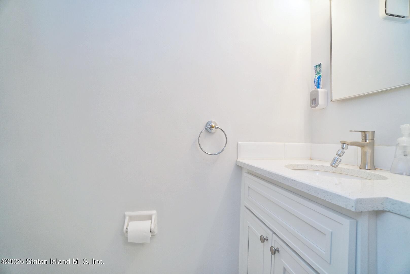 168 Rosedale Avenue Staten Island, NY 10312 - Photo 10 of 21 a bathroom with a sink vanity and a mirror