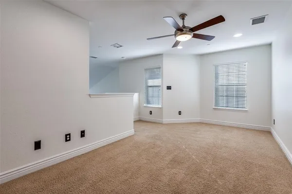 an empty room with closet and windows