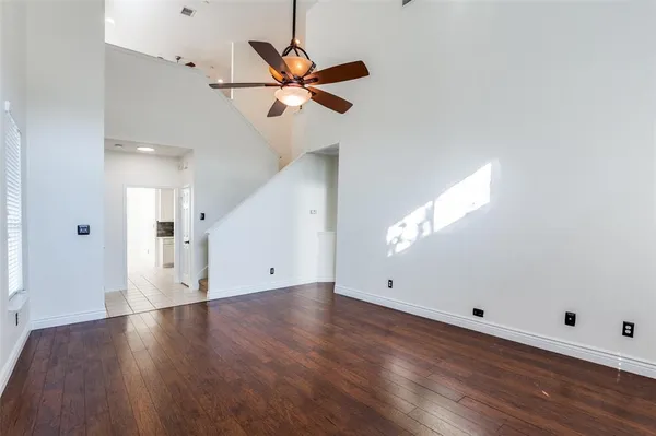 a view of a room with wooden floor and white walls