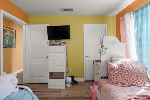 a bedroom with a bed and flat screen tv