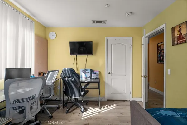 a view of a workspace with furniture and a window