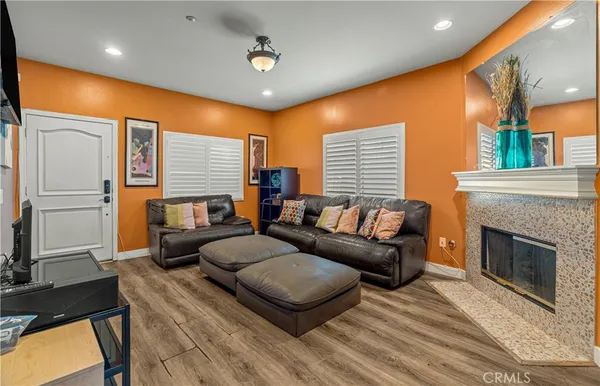 a living room with furniture a fireplace and a flat screen tv