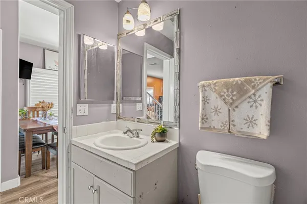 a bathroom with a sink a toilet and a mirror