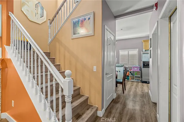 a view of hallway with wooden floor and stairs