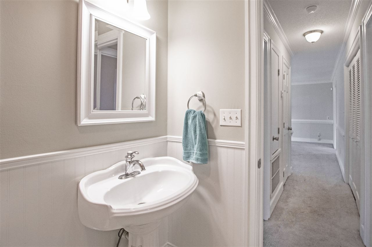 6909 Sandringham Drive Raleigh, NC 27613 - Photo 12 of 24 Updated bath looking down the hallway to the family room