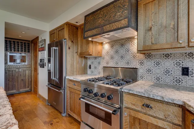 a kitchen with granite countertop a stove and a refrigerator