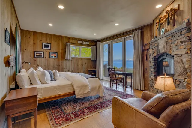 a spacious bedroom with a large bed and a large window