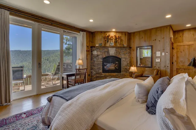 a bedroom with a bed and glass door