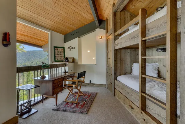 a bathroom with a double vanity sink a mirror and a bathtub