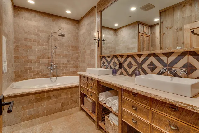 a bathroom with a sink a mirror and a shower