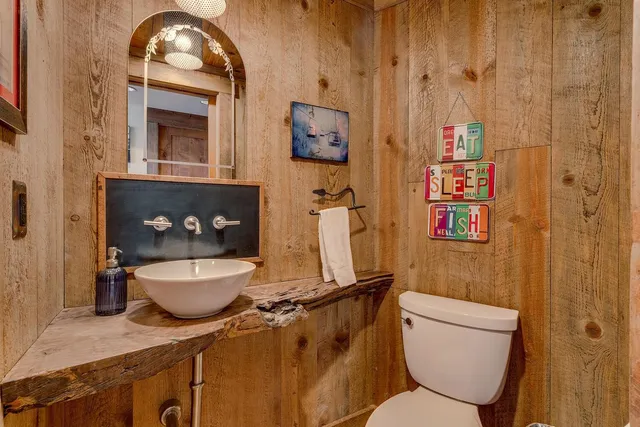 a front view of house with yard and trees in the background