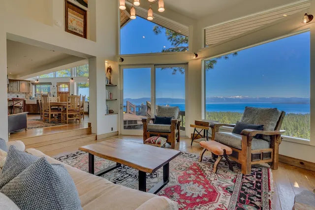 a living room with furniture a rug and a table