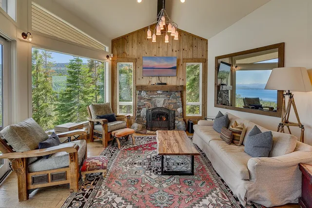 a living room with furniture fireplace and a large window