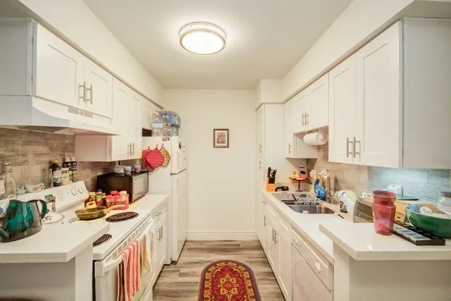a kitchen with a sink stove and cabinets