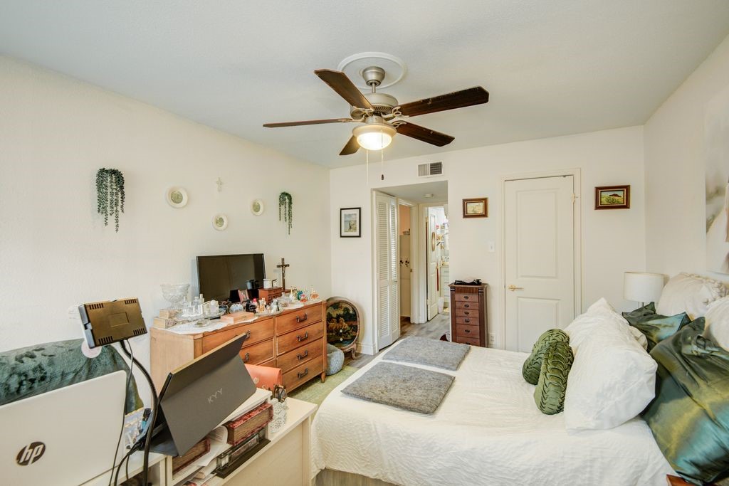 845 Augusta Drive, Unit 6 Houston, TX 77057 - Photo 6 of 8 a bedroom with a bed and a chair