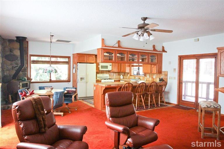 272 Chimney Rock Road Stateline, NV 89449 - Photo 22 of 35 a living room with furniture a chandelier and a floor to ceiling window