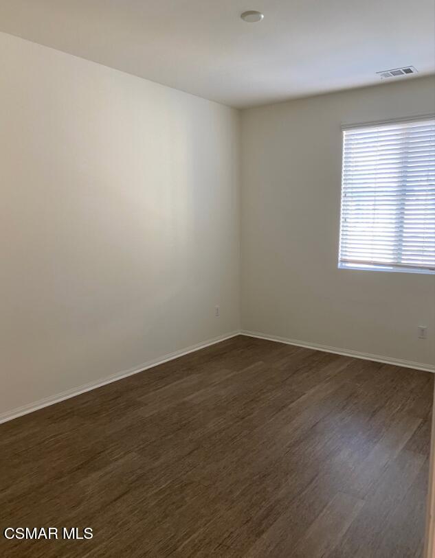 2234 Rolling River Lane, Unit 3 Simi Valley, CA 93063 - Photo 7 of 13 an empty room with wooden floor and windows