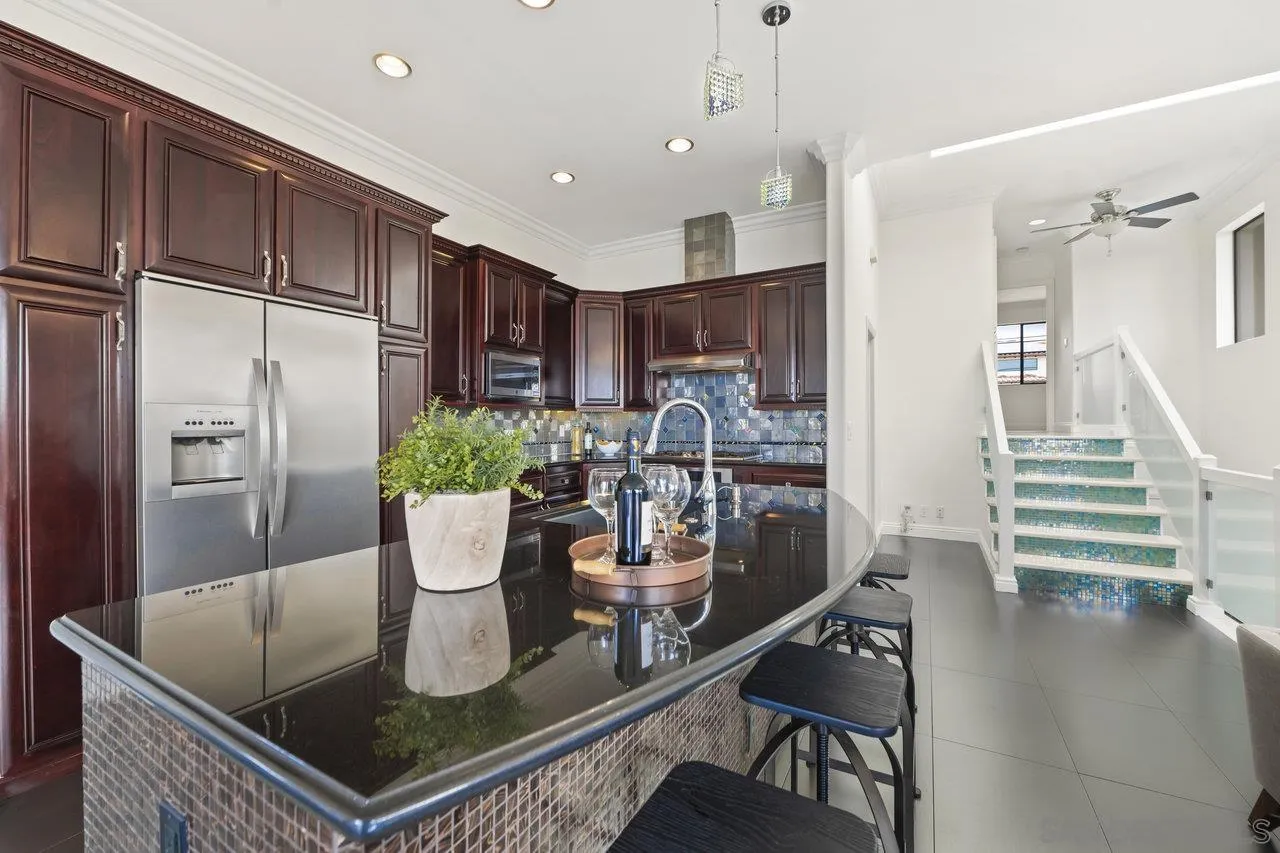 1528 Summit Avenue Cardiff, CA 92007 - Photo 5 of 13 a kitchen with a dining table chairs and refrigerator