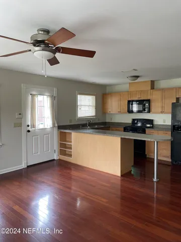 a view of kitchen with sink and wooden floor