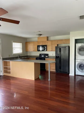a kitchen with granite countertop stainless steel appliances and wooden cabinets