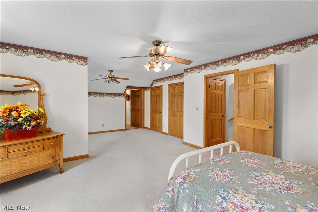 10909 Ruby Road Cambridge, OH 43725 - Photo 23 of 34 Carpeted bedroom with two closets and ceiling fan