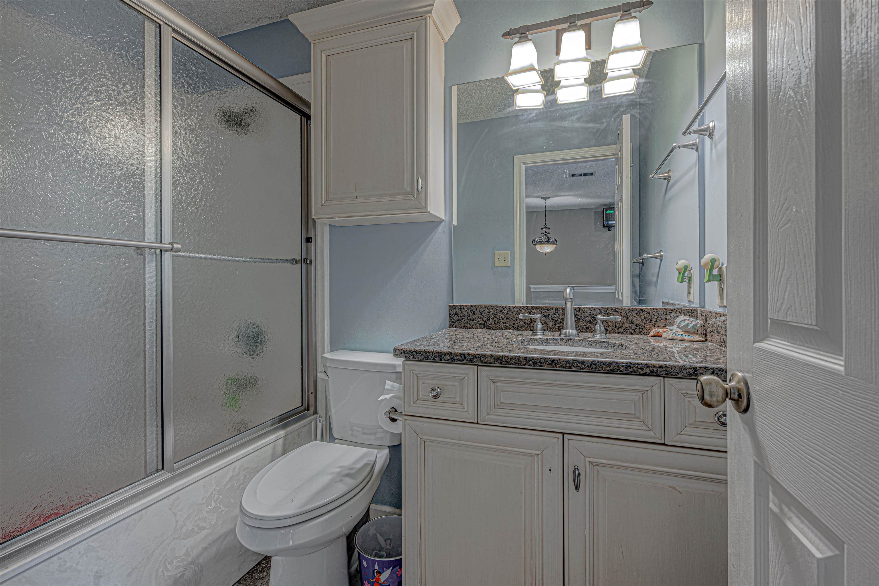 765 Pine Grove Cove Collierville, TN 38017 - Photo 23 of 31 a bathroom with a granite countertop sink toilet a mirror and shower