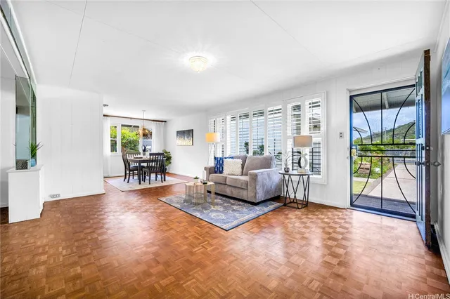 a living room with furniture and large windows