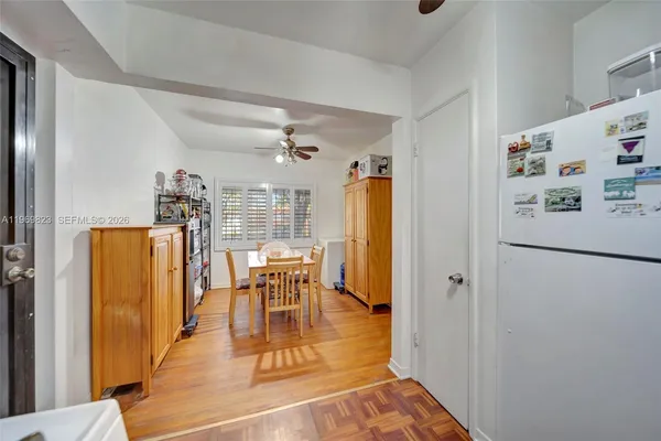 a kitchen with a refrigerator a stove top oven a sink and cabinets