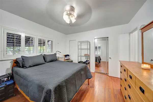 a bedroom with furniture and a flat screen tv