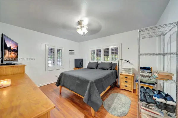 a spacious bedroom with a large bed and a dresser