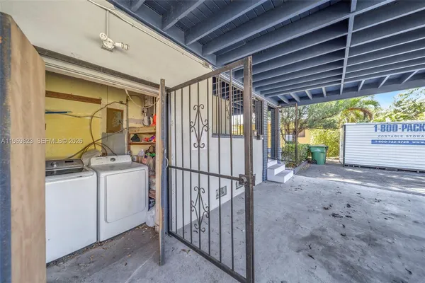 a view of a house with backyard and a tree