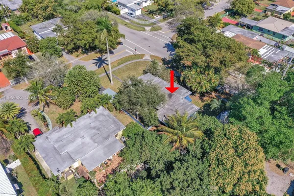 an aerial view of residential houses with city view