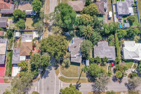 an aerial view of a house with a yard and garden