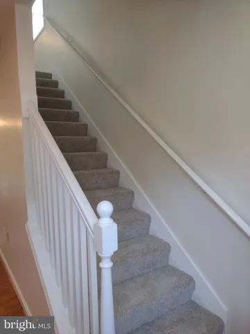 a backyard of a house with barbeque oven table and chairs