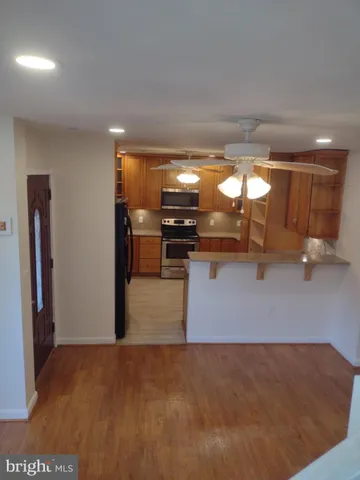 a kitchen with stainless steel appliances granite countertop a stove and a refrigerator