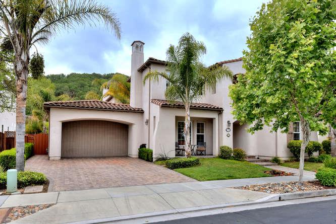 2820 Club Drive Gilroy, CA 95020 - Photo 2 of 43 a front view of a house with a garden and palm trees