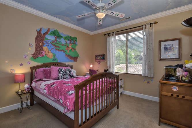 2820 Club Drive Gilroy, CA 95020 - Photo 26 of 43 a bedroom with a bed and a chandelier