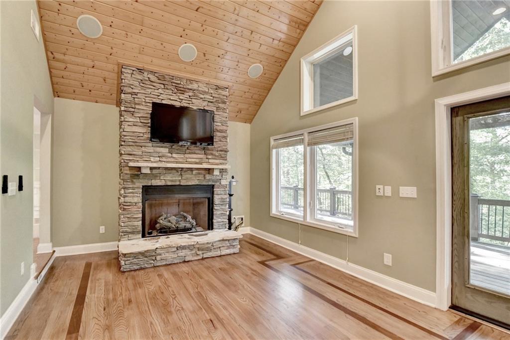 975 Timber Lake Trail Cumming, GA 30041 - Photo 18 of 82 a living room with a fireplace and windows