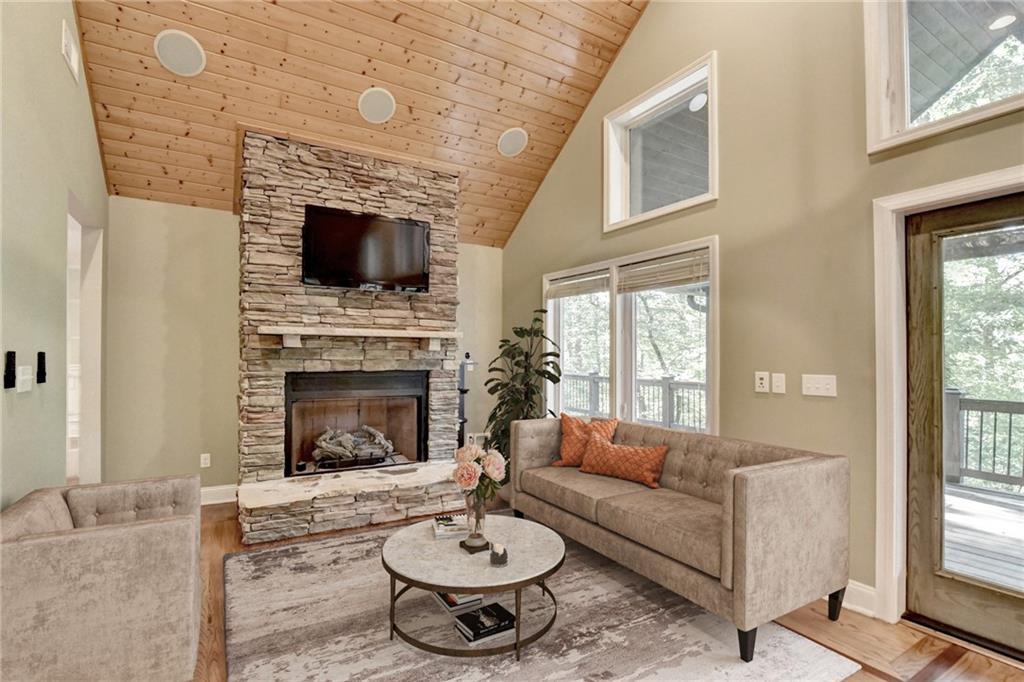 975 Timber Lake Trail Cumming, GA 30041 - Photo 19 of 82 a living room with furniture a fireplace and a flat screen tv