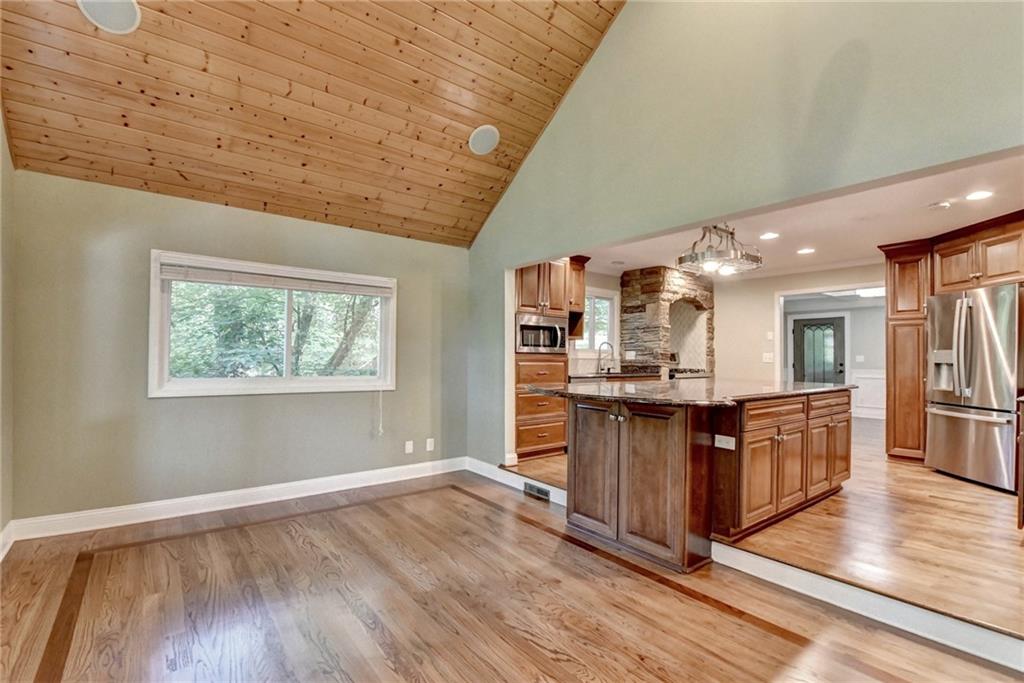 975 Timber Lake Trail Cumming, GA 30041 - Photo 25 of 82 a kitchen with stainless steel appliances granite countertop a stove and a wooden floors