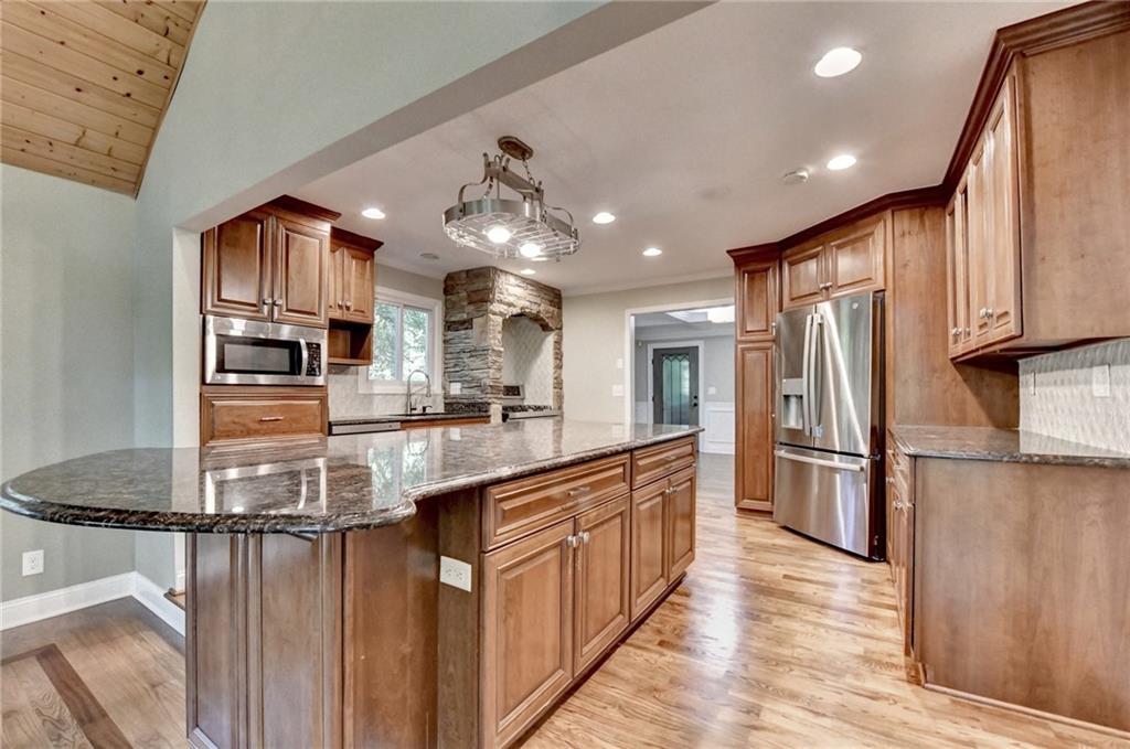 975 Timber Lake Trail Cumming, GA 30041 - Photo 27 of 82 a kitchen with stainless steel appliances granite countertop a refrigerator a stove oven and white cabinets