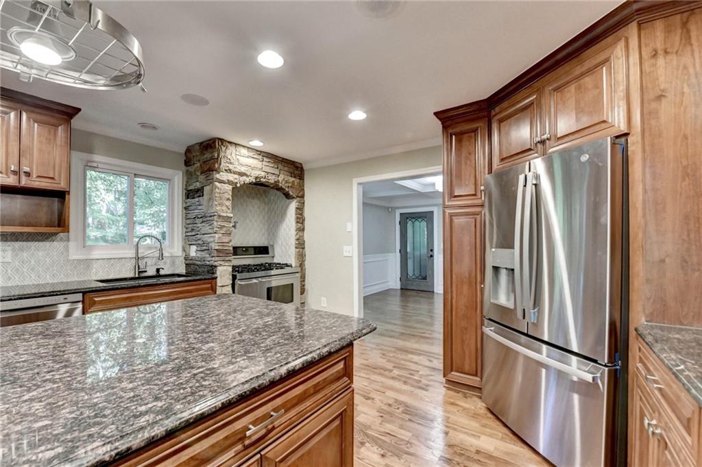 975 Timber Lake Trail Cumming, GA 30041 - Photo 28 of 82 a kitchen with stainless steel appliances granite countertop a refrigerator a oven and a sink with granite countertops